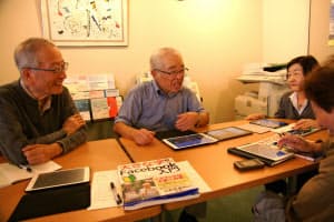 シニアの初心者にフェイスブックを教える牧壮さん(左から2番目、東京・千代田の砂防会館)